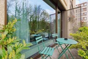 a patio with a table and chairs on a balcony at limehome Munich Fritz-Erler Str in Munich