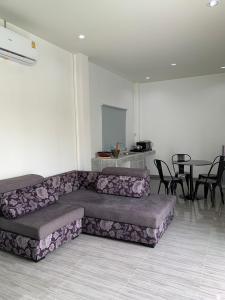 uma sala de estar com um sofá e uma mesa em กิจตรงวิลล์ รีสอร์ท Kittrongvill em Ubon Ratchathani