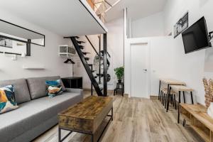 a living room with a couch and a table at Madrid Villaverde - Apartamentos acogedores, AC in Madrid