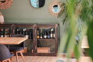 a cabinet filled with bottles of wine in a room at Le Sens Six in Montpellier