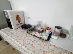 a table with a coffee maker on it with a counter top at FRIENDS House - Central Station - Self Check-in in Braşov