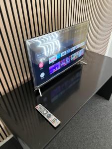 a television sitting on a table with a remote control at Skuldelev kro in Skibby