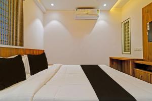 OYO Hotel Delight Stay في إندوري: غرفة نوم بسرير كبير وخزانة