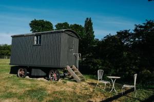 a green shipping container with a table and chairs at Gallery at Abbey Hall, Eye in Eye