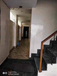 an empty hallway with stairs in a building at Hotel Poojan Heritage in Haridwār