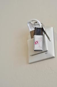 a white bag with a key on top of it at Otel Sınal in Kocaeli