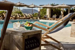 a bowl of fruit on a table next to a pool at Finca Serena Mallorca, Small Luxury Hotels in Montuiri
