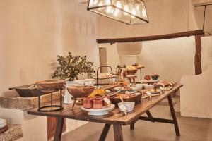a table filled with food on top at Finca Serena Mallorca, Small Luxury Hotels in Montuiri