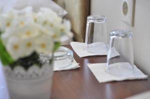 a wooden table with a vase of flowers and napkins at Otel Sınal in Kocaeli