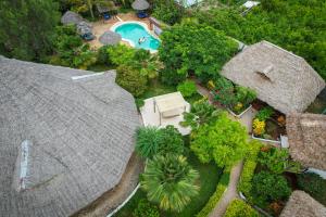 an aerial view of a house with a swimming pool at Mawimbi Bungalows in Nungwi