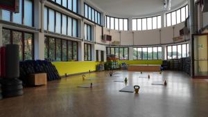a gym with yoga mats on the floor in a building at Immobiliare P&P - Arena House in Genova