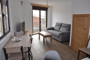 a living room with a couch and a table at La Costurera in Navatalgordo