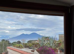 a view of a mountain from a window at Vedi Napoli in Vacanza in Naples
