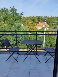 a table and two chairs sitting on a balcony at Apartament AMBRA II in Jantar