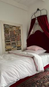 a bedroom with a bed with a red head board at Siedlisko Blanki in Suryty