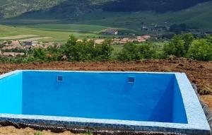 a blue swimming pool on top of a hill at Apartement Cristina in Petreştii de Jos