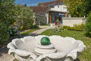 a green egg sitting on top of a white couch in a yard at L'élégante in Loches