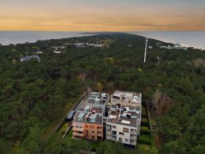 an aerial view of a building in the forest at Surf&biKe apartments Jurata in Jurata
