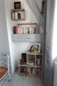 a book shelf in a stairway with books at Gîte Le Chardet 