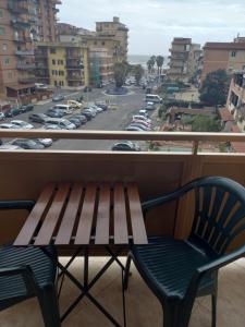 a bench on a balcony with a view of a street at FERRARO ALLOGGIO TURISTICO in Ladispoli