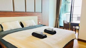 - une chambre avec un lit et 2 serviettes dans l'établissement The Astra one bedroom apartment, à Chiang Mai
