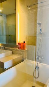 La salle de bains est pourvue d'une douche et d'un lavabo. dans l'établissement The Astra one bedroom apartment, à Chiang Mai