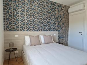 a bedroom with a white bed and a wall mural at Residence Moretti piano secondo in Udine