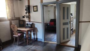 Una puerta que conduce a una habitación con mesa y escritorio en Ferienhaus Am Moselstausee, en Sankt Aldegund