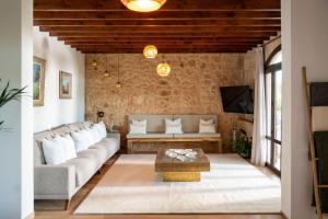 a living room with a couch and a table at Cas Metge Matas in Santa Maria del Camí