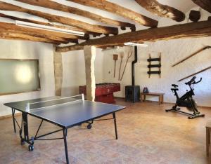 a room with a ping pong table and a projector at Casa Rural Cal Caminer in Guimerá