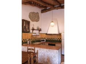 a kitchen with a large island in the middle at Casa Rural Cal Caminer in Guimerá