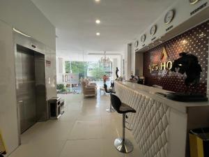 a lobby with a bar and a living room at A25 Hotel - 255 Lê Thánh Tôn in Ho Chi Minh City