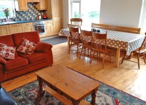 a living room with a couch and a table at M038 Accony, Louisburgh in Louisburgh