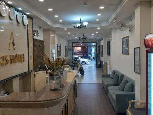 a lobby of a store with couches and a car at A25 Hotel - 35 Mạc Thị Bưởi in Ho Chi Minh City