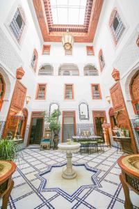 a large building with a fountain in the middle of a room at Dar Dalila Fes in Fez