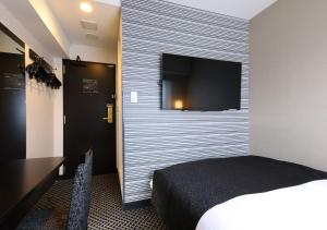 Postel nebo postele na pokoji v ubytování APA Hotel Ueno Ekikita