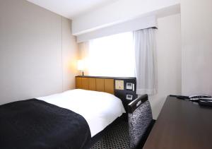 Postel nebo postele na pokoji v ubytování APA Hotel Ueno Ekikita