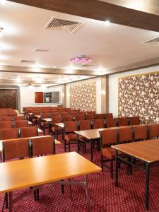 an empty lecture hall with tables and chairs at Hotel Alma-Ata in Borovoye +40 photos