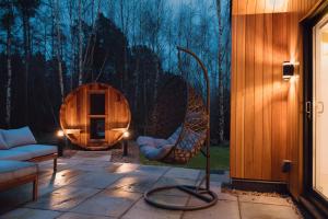 a patio with two wicker chairs in front of a window at Newlands Lodges in Shotley Bridge