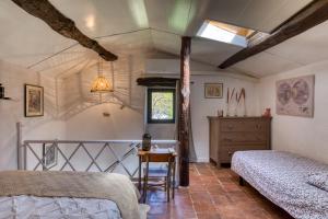 a bedroom with two beds and a table at Maison de village in La Tour-sur-Orb +25 photos