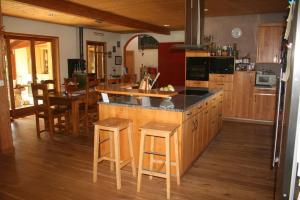 a kitchen with a large island with a counter top at Le Loft House Jaun in Im Fang