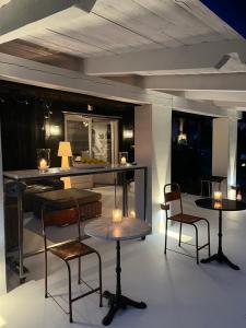 a room with two tables and chairs with candles on them at Siedlisko Blanki in Suryty