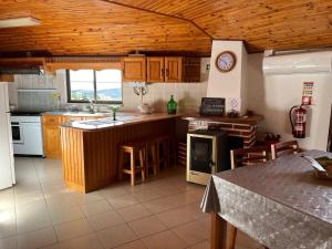 a kitchen with a counter and a stove top oven at Casa do Castelo- Serra da estrela in Covilhã