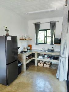 a kitchen with a black refrigerator in a room at Giraffe Studio @ Kruger in Marloth Park