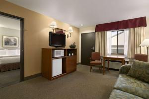 a hotel room with a bed and a television at Baymont by Wyndham Seattle/Kirkland WA in Kirkland