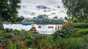 a group of people in boats in a pond in a greenhouse at Peaceful Home Berrylands Surbiton Surrey UK - Free Parkings in Surbiton