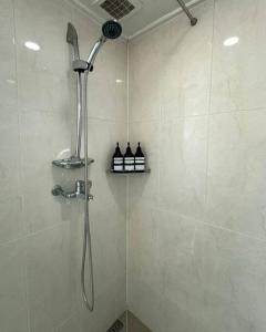 a shower with a shower head in a bathroom at COEX VIP 15 New Open [2 Queen beds] in Seoul