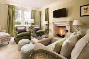 a living room with a couch and a fireplace at Lane Cottage in Coldstream