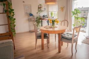 a dining room table and chairs with flowers on it at Heart of Mitau in Jelgava