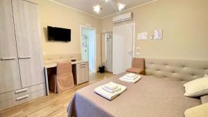 TV a/nebo společenská místnost v ubytování Oasi Perla Del Mare Rooms